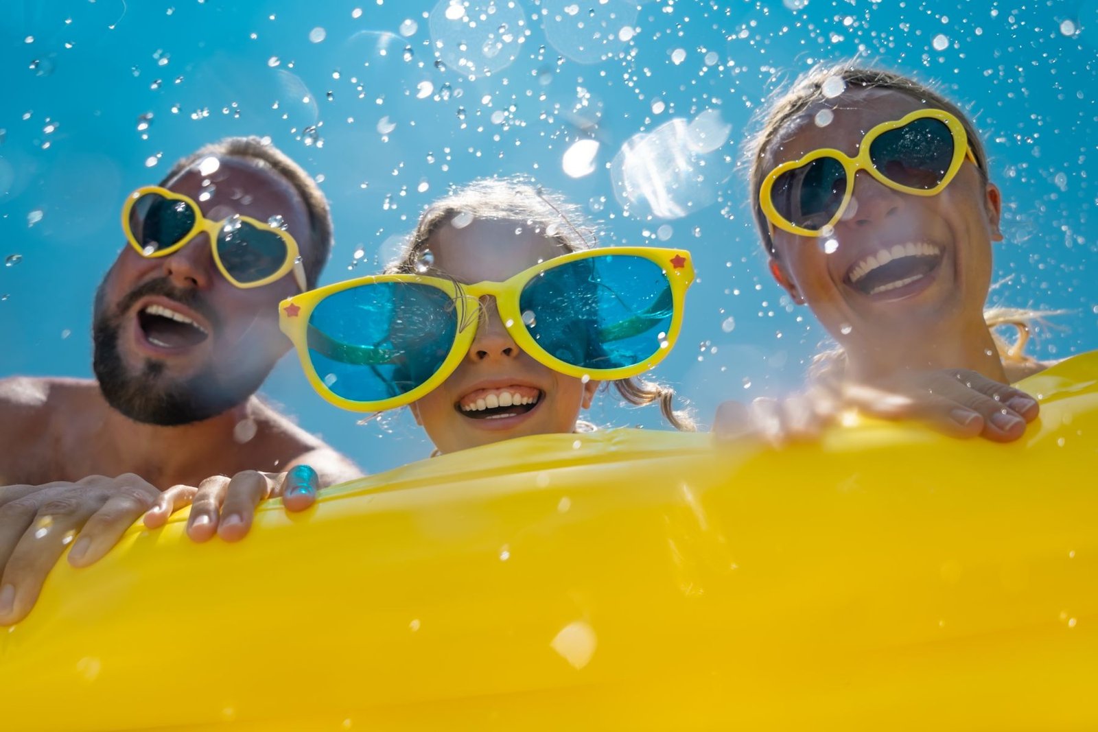 A family laughing together at the pool